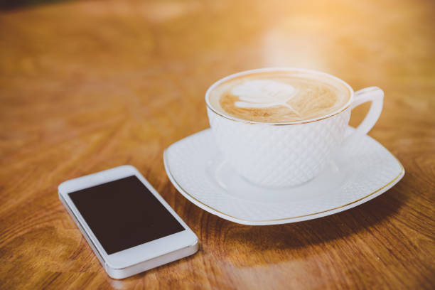 istock cup of coffee tablet and smart phone on wooden table 942334050
