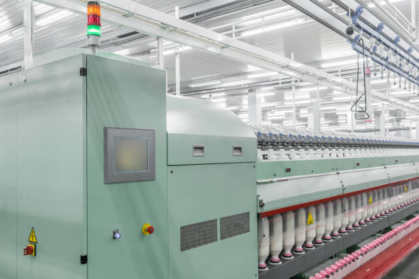 istock spools of thread at a textile factory 942338878