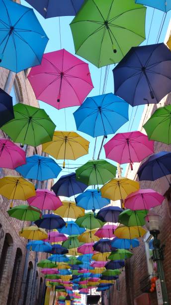 istock Colorful Umbrella Lined Street 942344256