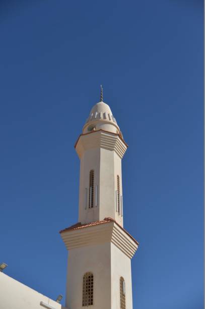 istock white minaret of mosque in blue sky 942344918