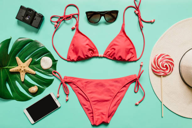 Summer vacation concept with pink bikini suit, hat and accessories