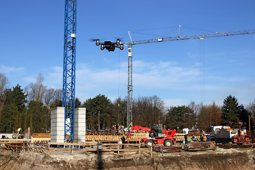 The drone flies over the construction site