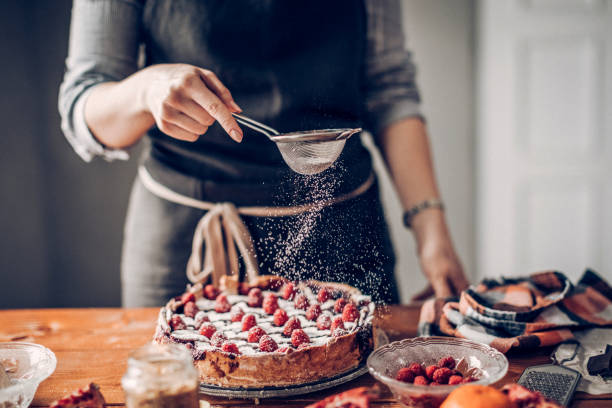 istock Young woman decorating cake 942345838