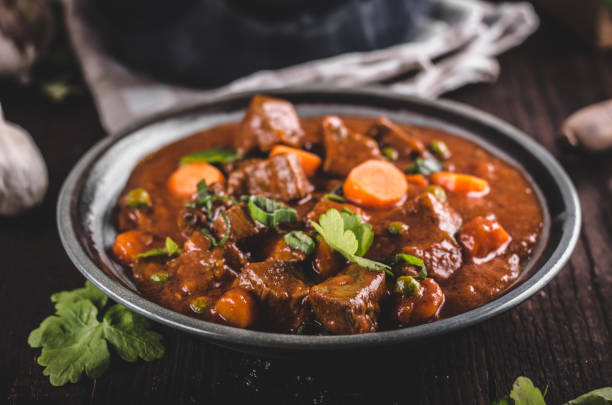 Beef stew with carrots Beef stew with carrots, food photography, lot of herbs inside stew beef stew stock pictures, royalty-free photos & images