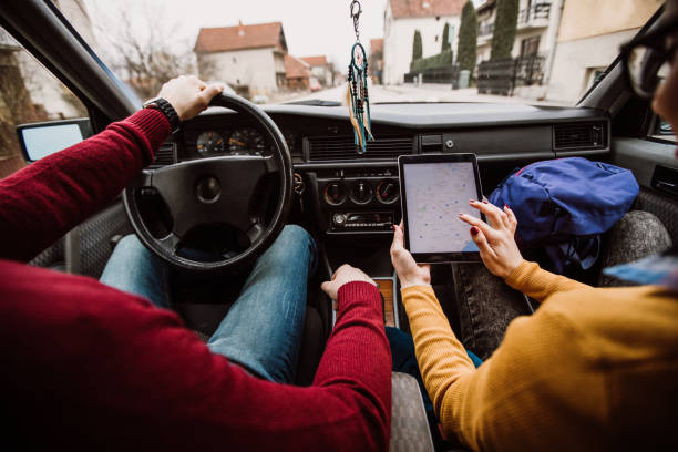 Couple on road trip Couple on road trip looking on digital tablet navigation system travel destinations 20s adult adventure stock pictures, royalty-free photos & images