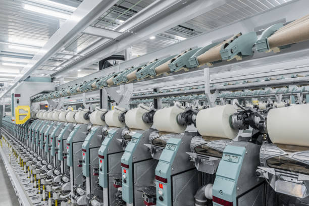 istock spools of thread at a textile factory 942350660