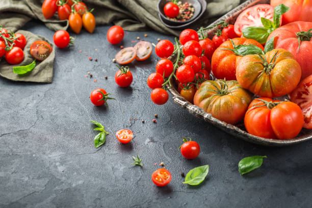 istock Assortment of ripe organic farmer red tomatoes on a table 942353694