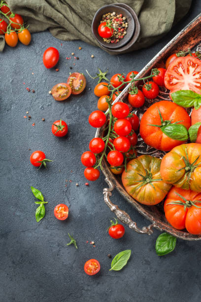 istock Assortment of ripe organic farmer red tomatoes on a table 942353844