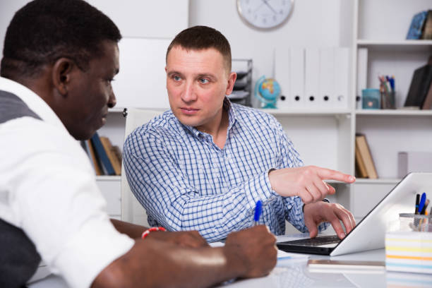istock Two businessmen working in the office at the laptop 942353884