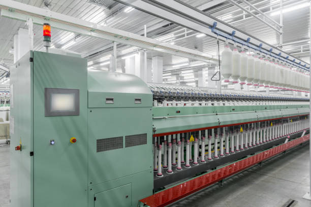 istock spools of thread at a textile factory 942354796