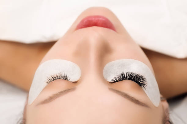 istock Eyelash Extension Procedure. Woman Eye with Long Eyelashes. Close up, selective focus 942355062