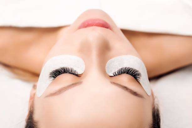 istock Eyelash Extension Procedure. Woman Eye with Long Eyelashes. Close up, selective focus 942360032