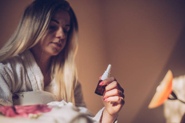 istock Sick girl with nasal spray 942360288