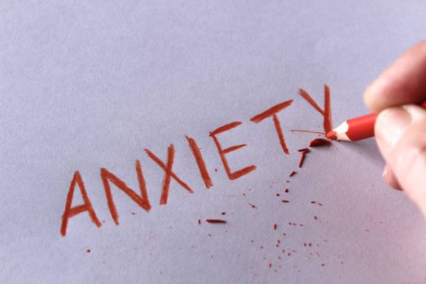 istock Anxiety concept. Word anxiety written on white paper 942360306