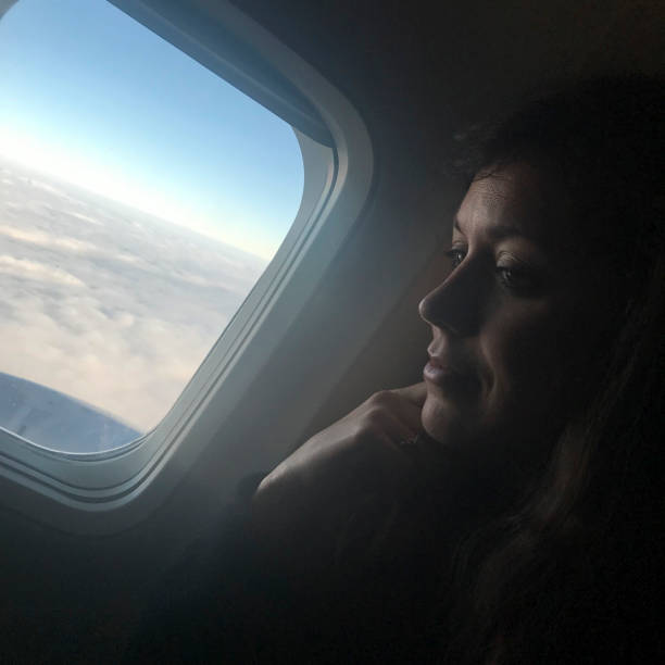 istock Young Woman on Airplane 942362776