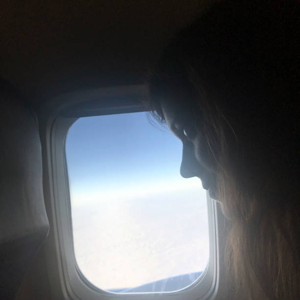 istock Young Woman on Airplane 942363344