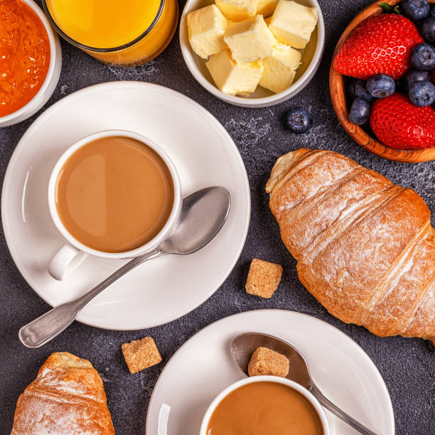 istock Breakfast with fresh croissants, orange juice and coffee, top view. 942364610