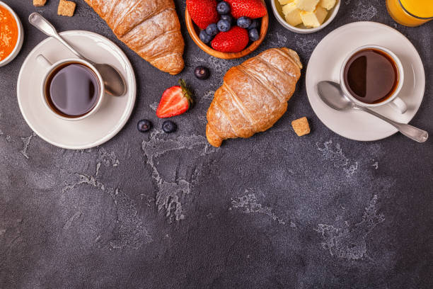 istock Breakfast with fresh croissants, orange juice and coffee, top view. 942364636