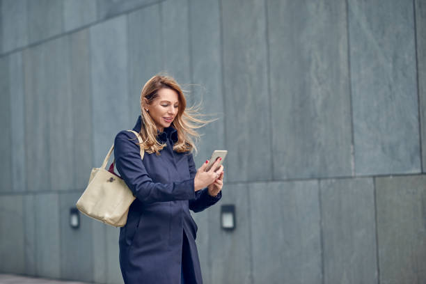 istock Middle-aged blond woman walking in the wind 942373130