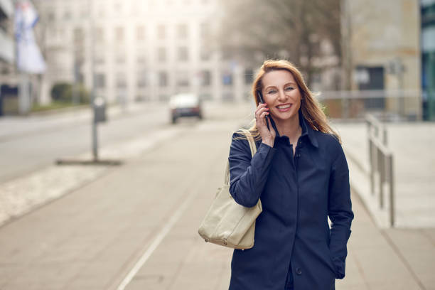 istock Attractive blond woman chatting on her smartphone 942373190