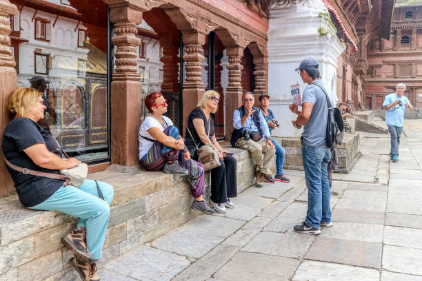 Tourists with Nepalese local guide in Nasal Chowk Courtyard, Kathmandu, Nepal stock photo
