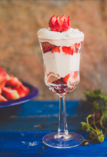 istock Yogurt with strawberries in glass cup on natural stone background. 942374732