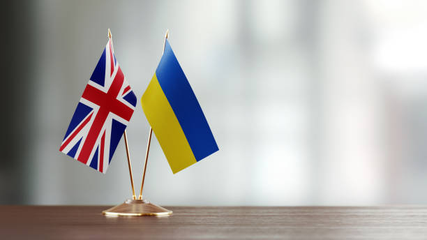 istock British And Ukrainian Flag Pair On A Desk Over Defocused Background 942381546