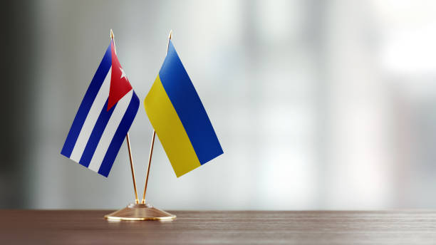 istock Cuban And Ukrainian Flag Pair On A Desk Over Defocused Background 942381604