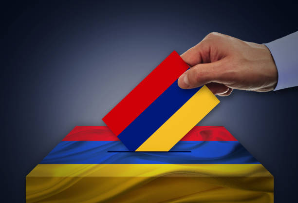 istock Man voting on elections in Armenia front of flag 942384836