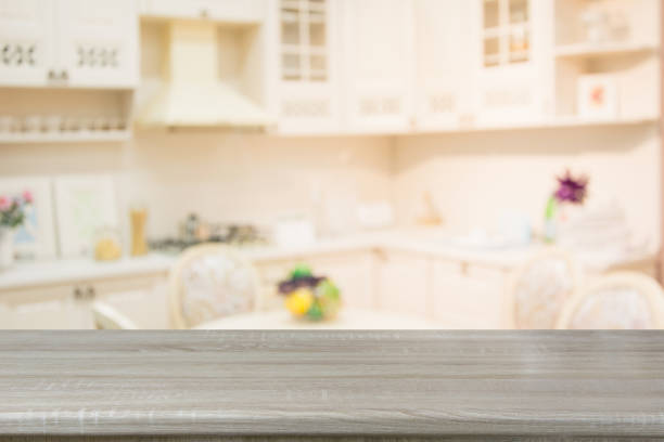 istock Blurred background. Empty wooden tabletop and defocused modern kitchen. 942390866