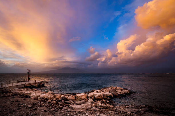 beautiful cloudscape at sunset, castellamare coastline at the gulf of naples with view on mount vesuvius volcano in italy.