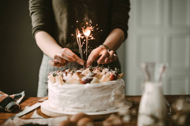 Sprinkles are all arround Woman making cake for celebration birthday cake stock pictures, royalty-free photos & images