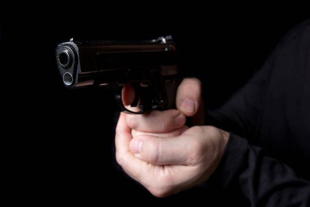 istock A firearm in the hands of a man defending or attacking 942400962