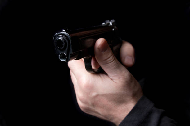 istock A firearm in the hands of a man defending or attacking 942400964