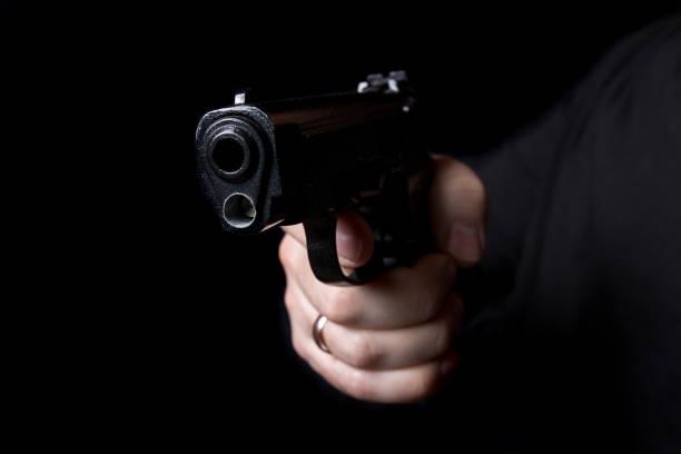 istock A firearm in the hands of a man defending or attacking 942400974