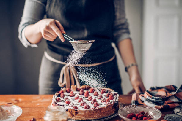 istock Young woman decorating cake 942403044