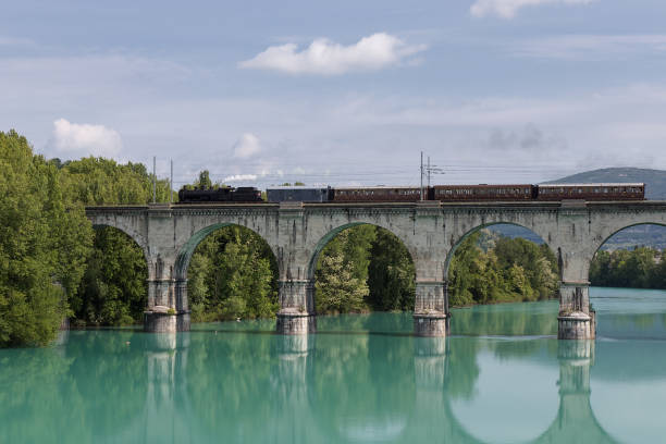 istock Old Steam Train driving over Soca River, Gorizia Stone Bridge, Italy 942403444