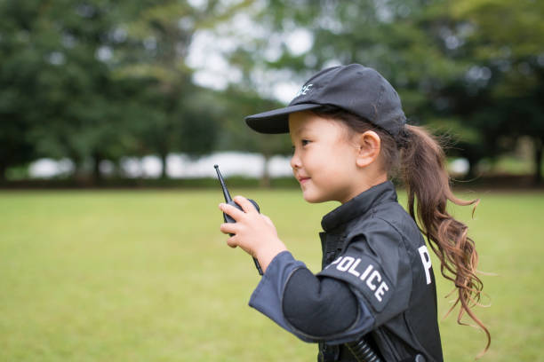 Little girl in police costume Little girl in police costume manhunt law enforcement stock pictures, royalty-free photos & images