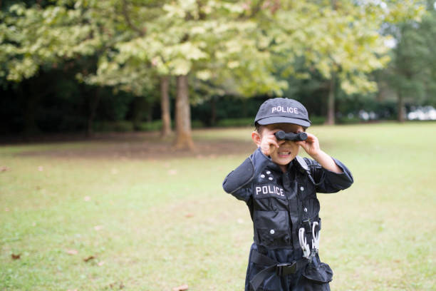 Little girl in police costume Little girl in police costume manhunt law enforcement stock pictures, royalty-free photos & images