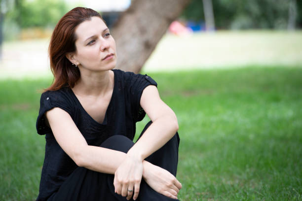 Young woman takes a break in the park stock photo