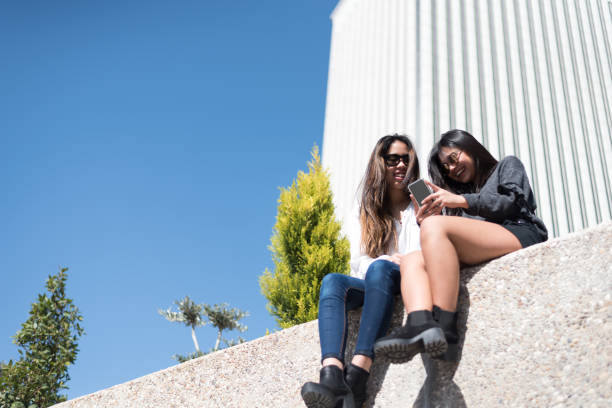 istock happy women enjoying a mobile phone and taking selfie 942406756