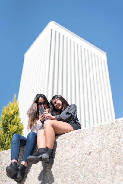 istock happy women enjoying a mobile phone and taking selfie 942406812