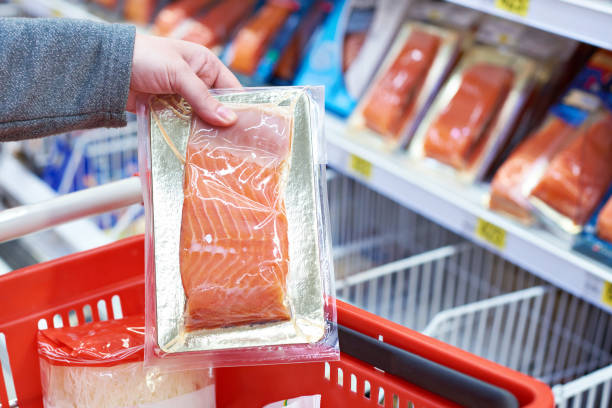 istock Pack of salmon in hand at store 942406840