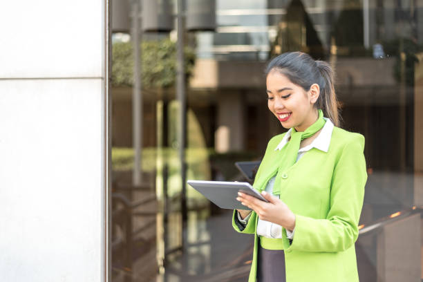 istock scort woman with tablet and mobile phone smiling 942407120
