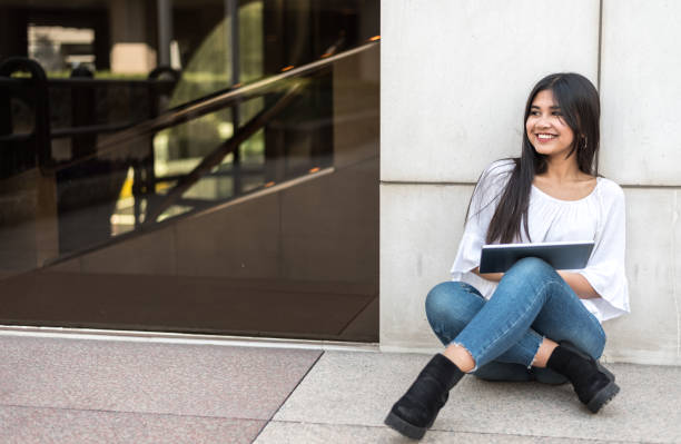 istock close up portrait student young woman with tablet 942407164