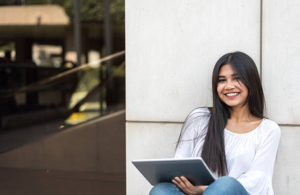 istock close up portrait student young woman with tablet 942407262