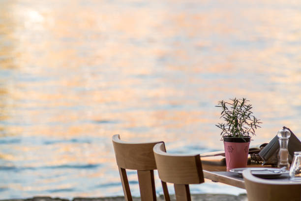 istock Idyllic dinner table at sunset in front of the sea 942407426