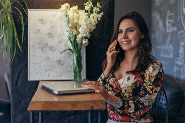 istock Young woman using a laptop at the cafe 942410272