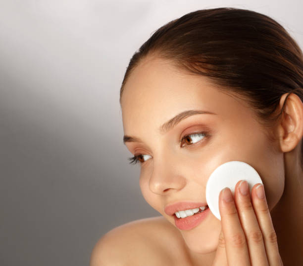istock Young woman removing make up from her face 942413494