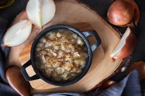 istock Fried onion in a frying pan on a wooden board 942421134